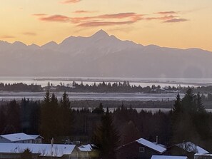 View of mountains, Kachemak Bay, and Homer Spit from the deck of Homer House