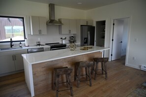 Gorgeous 9 foot kitchen island with barstool seating and full amenities. 