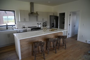 Gorgeous 9 foot kitchen island with barstool seating and full amenities.