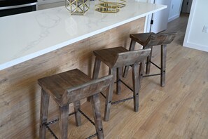 Huge nine foot island with three barstools