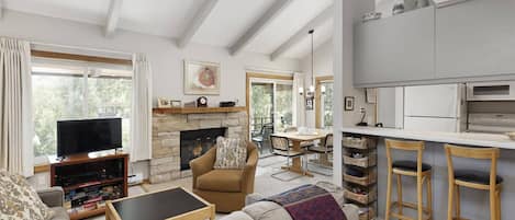 The open floor plan, vaulted ceilings and large windows and sliding door create a very inviting space to vacation.