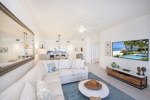 Living area furnished with a new plush sectional sofa.