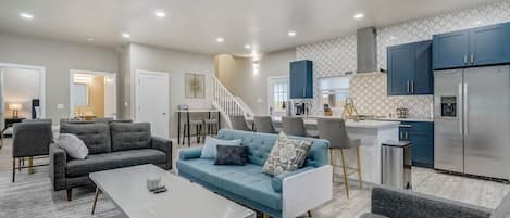 As you walk in, you will be greeted by 10ft+ ceilings and the open floorplan on the main level to include the kitchen, a large built in island, living room, dining room, breakfast table, and the washer and dryer right there for easy access!