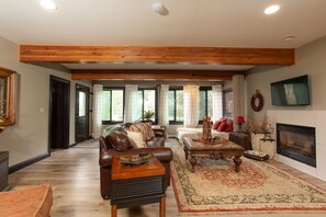 Living room has views to the outdoors.  See wildlife like fox and moose!