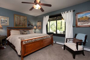 Primary bedroom with king bed and ensuite bathroom.
