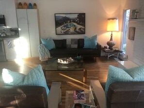 Living Room on the main floor w Gas Modern fireplace and Mid Century Decor