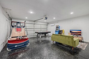 Garage game room with air hockey and arcade games