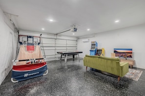 Garage game room with air hockey and arcade games