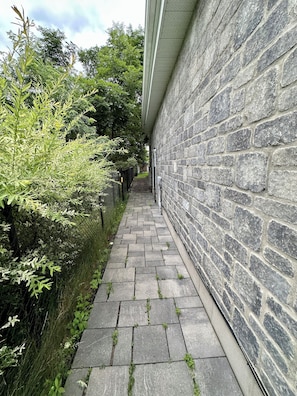 The narrow next to the main House and leading to the entrance door...