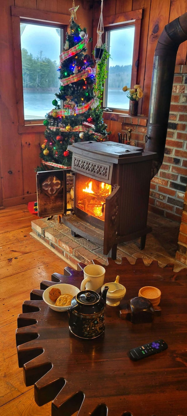 Hot English tea with cookies, curled up with blanket sitting next to wood stove
