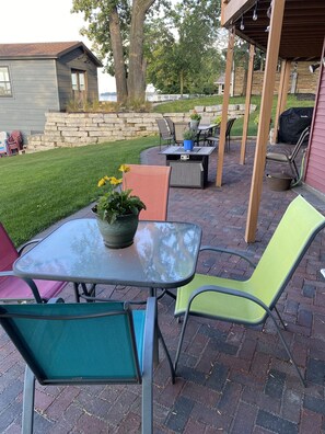 Lower patio with tables and chairs for 12 and grill