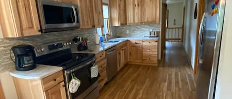 Kitchen with all new appliances fully stocked and ready for you!