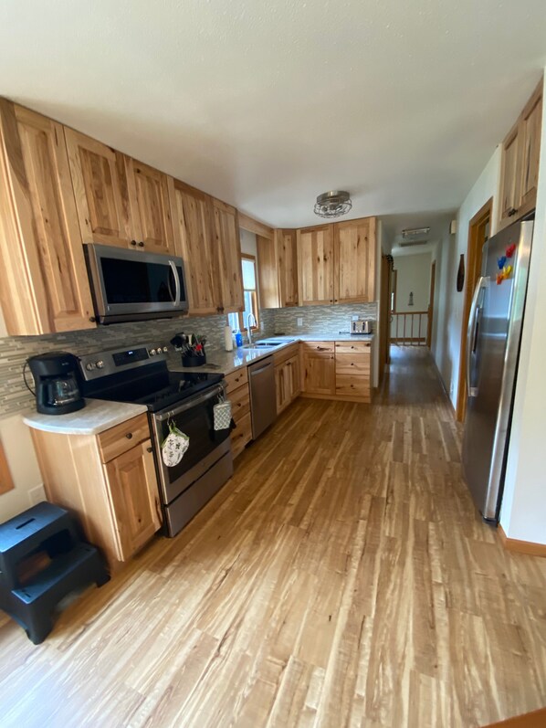 Kitchen with all new appliances fully stocked and ready for you!