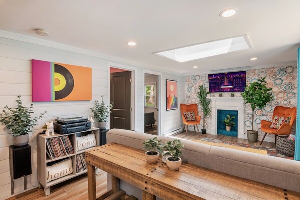 Our colorful living room with a pull-out couch and a sweet record collection!