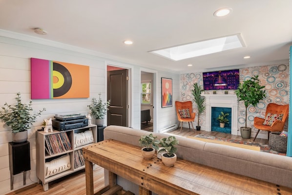 Our colorful living room with a pull-out couch and a sweet record collection!
