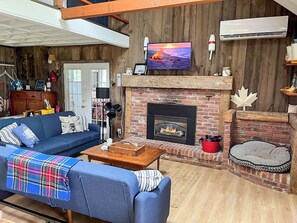 Spacious living area with gas fireplace. TV not pictured