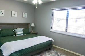 Primary bedroom with king bed and TV