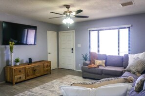 Front room offer plenty of seating space and large screen TV.