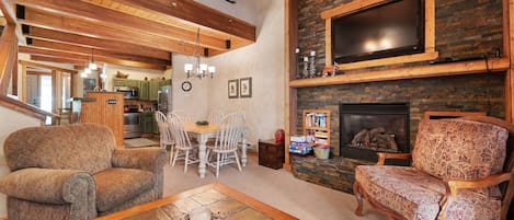 Warm woods around a cozy living room, open right to the kitchen and dining, inviting for family and friends!