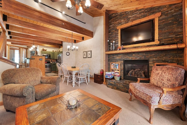 Warm woods around a cozy living room, open right to the kitchen and dining, inviting for family and friends!