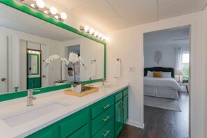 Three separate areas as part of this bathroom - shower room, toilet room and large bathroom counter with two sinks to get ready at!