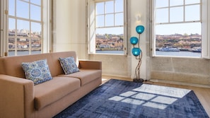 Lovely living room, with a breathtaking view to the river and lots of big windows to provide tons of natural light and enjoy a summer evening in the best way #breathtaking #stunning #amazing #airbnbporto #lovelystay