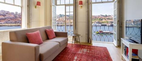 Stunning living area, with a breathtaking view to the river and a TV for your entertainment, perfect for a lovely summer evening #sublime #dreamy #airbnbporto #lovelystay