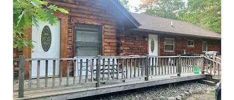 Front view with deck, table and chairs, grill.