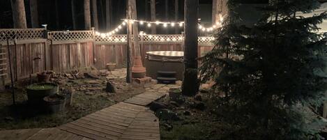 Relax in the hot tub and under the trees and lights after a day of hiking! 