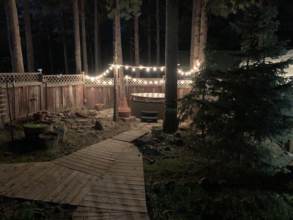 Relax in the hot tub and under the trees and lights after a day of hiking! 