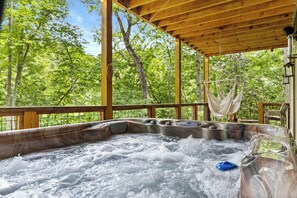 Gather outside and enjoy the backyard and river from the hot tub and porch hammocks.