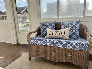 Sitting area  (NS facing)  enclosed front porch/screened sunroom w/ceiling fan.