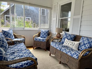 Sitting area  (NS facing)  enclosed front porch/screened sunroom w/ceiling fan.