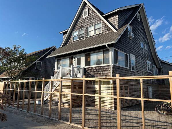 2024 House lift photo of front of home with private fence/gate.  (East facing)