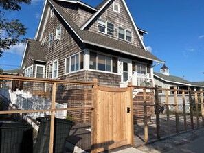 2024 House lift photo of front of home with private fence/gate.  (East facing)