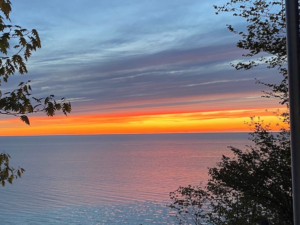 EXTERIOR:  A beautiful sunset on Lake Michigan looking from the cottage.