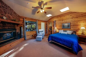 Primary bedroom with queen-size bed (note, the fireplace is not functional)