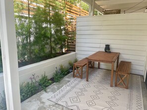 Backyard (enclosed) w/ table and BBQ