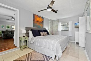 The primary bedroom offers a comfy King sized bed with a private ensuite bathroom and direct pool access with french doors.