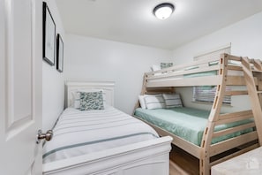 Comfortably sleep up to four people in the second guestroom. Includes a twin over full bunk and an individual twin bed.