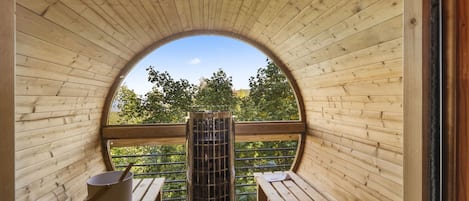 Barrel sauna has a panorama viewing window to take in the great outdoors!