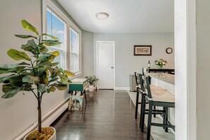 Spacious access to dining room with counter-height seating and record player. 
