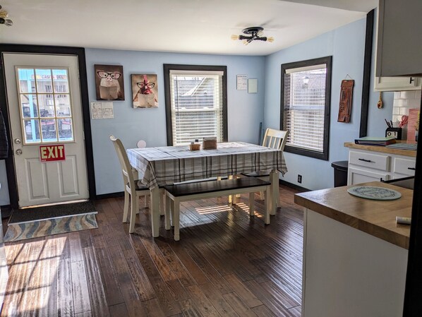 Dining for up to 8 with view of gazebo and fenced in yard.