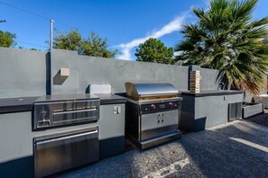 outdoor kitchen with a gas grill connected to the natural gas