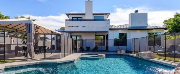 Pool is Heated Year Round with Child Proof Fence so families can relax without worries.