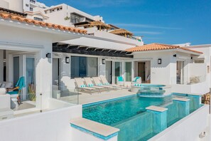 Poolside view of the patio and exterior of villa