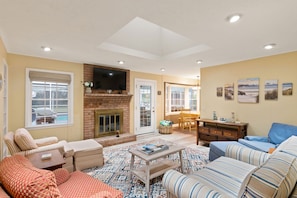 Family room has a 50 inch smart TV and comfortable seating for 5