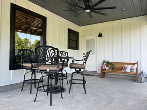 Side entrance.  Eating area, church pew bench, fan