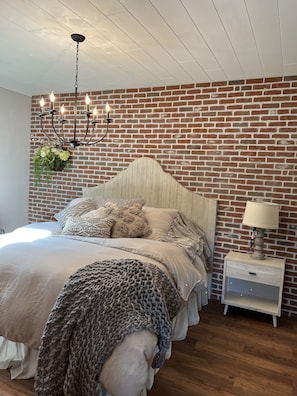 Brick wall in Master bedroom, with king size bed, 
