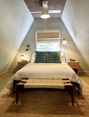 Guest bedroom upstairs with tv, vanity, blackout shades 